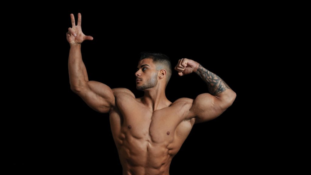 Alt text for an image of a bodybuilder posing, showcasing their muscular physique.